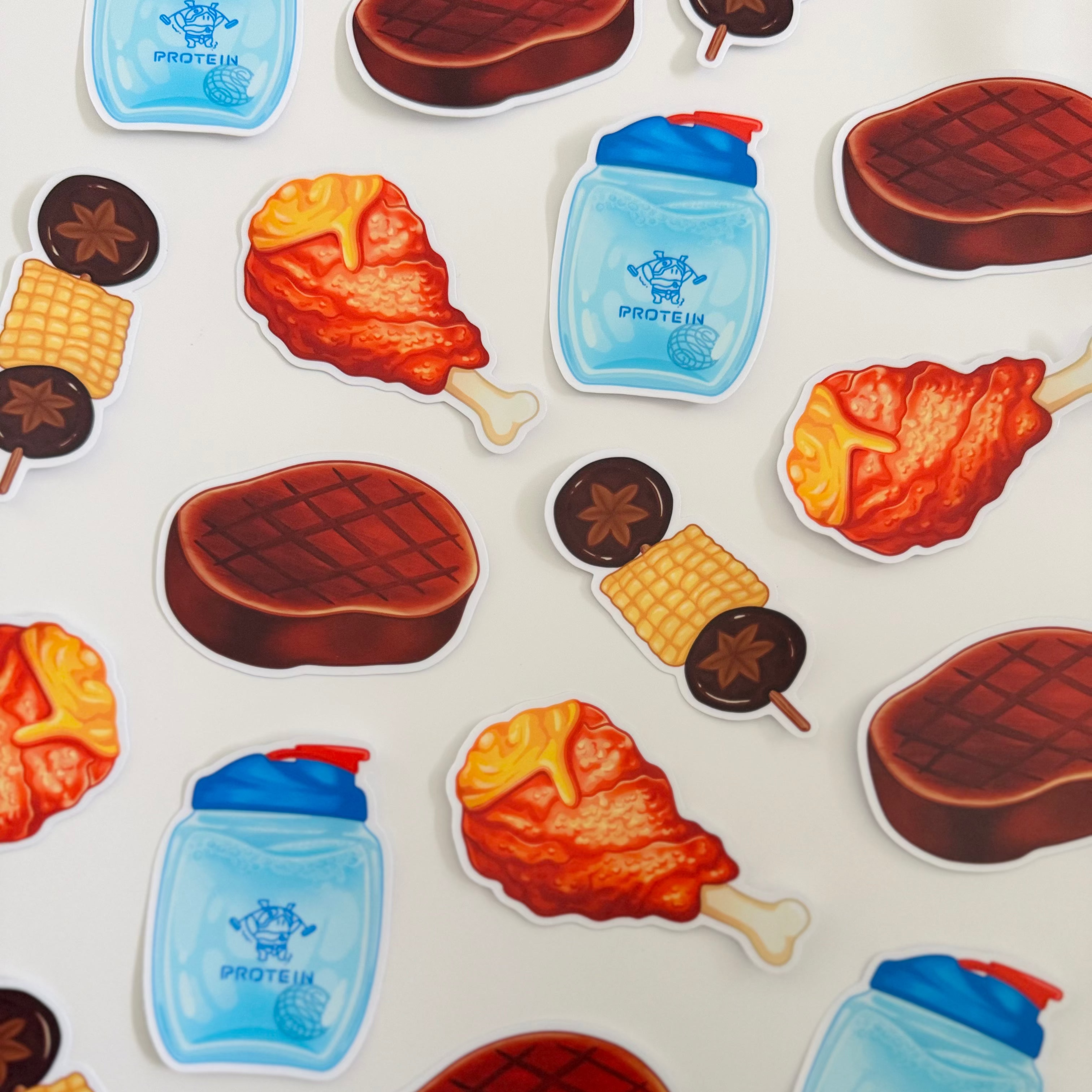 Sticker set with food items including meat, veggie & corn on stick, and protein bottle, fried chicken on a white background